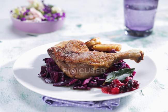Duck leg on savoy cabbage with cranberries — Stock Photo