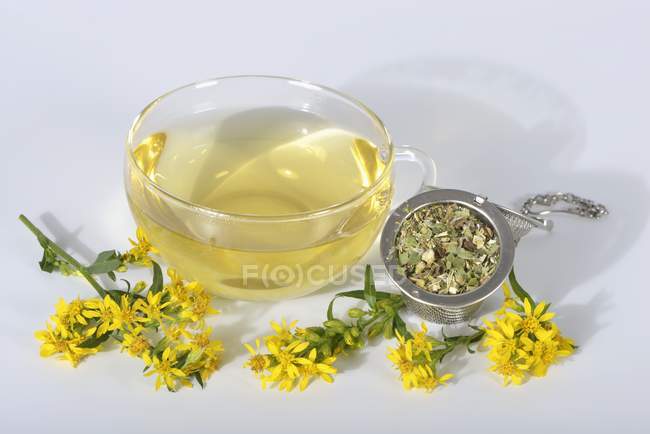 Goldenrod tea in glass cup — Stock Photo