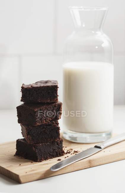Fresh brownies and  jug of milk — Stock Photo