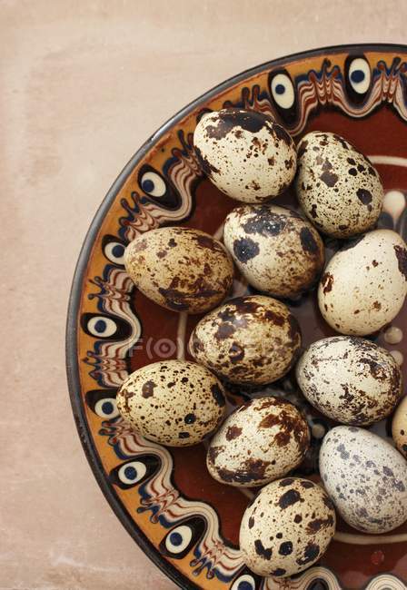 Quail eggs on patterned plate — Stock Photo