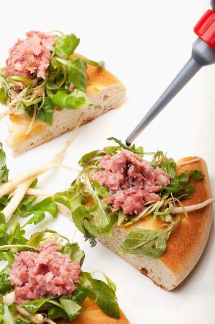 Pizza with lamb lettuce and salami — Stock Photo