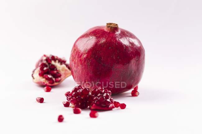 Fresh pomegranate with pieces — Stock Photo