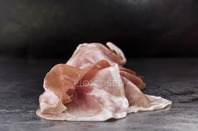 Slices of dry-cured ham — Stock Photo