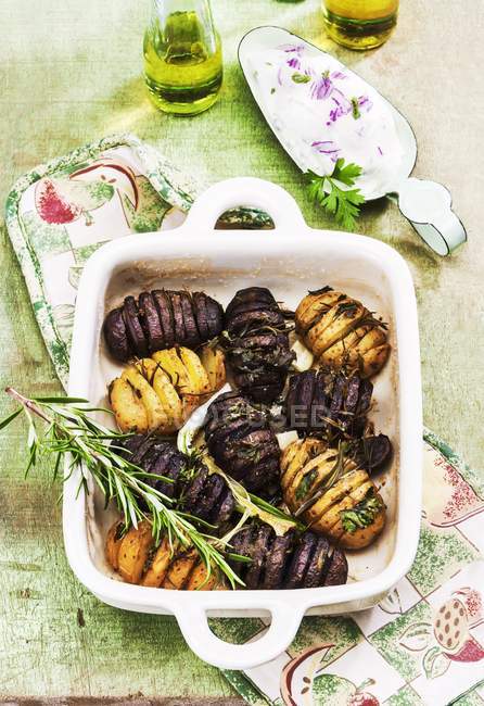 Yellow and purple hasselback potatoes — Stock Photo