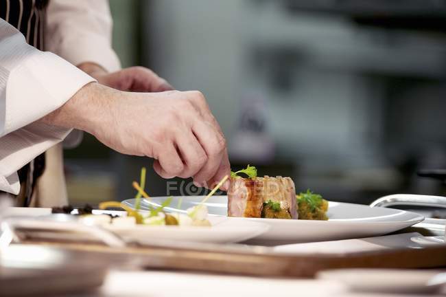 Chef plating up pork — Stock Photo