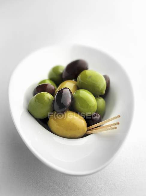 Mixed olives with toothpicks — Stock Photo