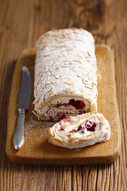 Closeup view of sponge roll with cranberry jam and cream — Stock Photo