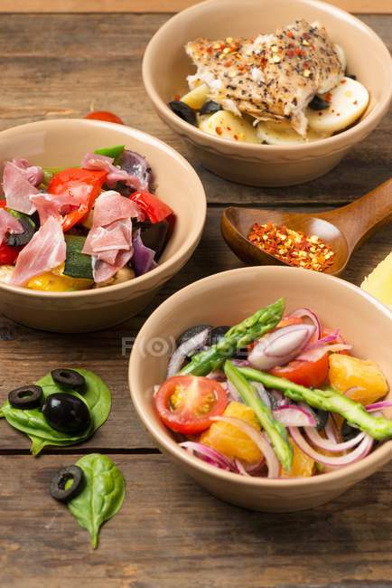 Different salads with asparagus and ham — Stock Photo