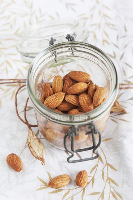 Almonds in storage jar — Stock Photo