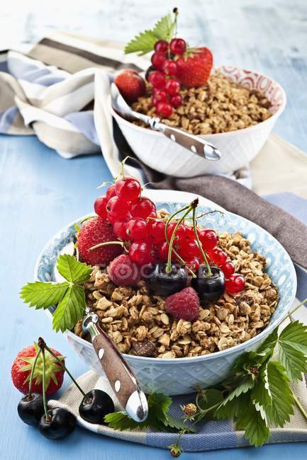 Oatmeal muesli with raspberries and cherries — Stock Photo