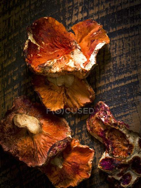 Closeup top view of fresh lobster mushrooms on rustic wood surface — Stock Photo