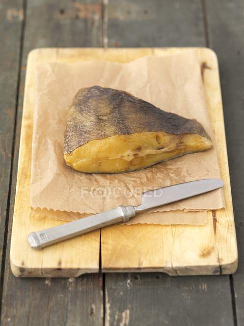 Smoked halibut piece on chopping board — Stock Photo