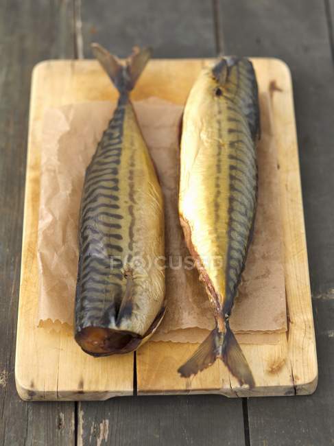 Smoked mackerel on chopping board — Stock Photo