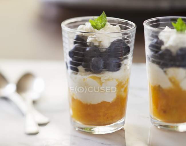 Closeup view of two glasses of blueberry and mango parfait — Stock Photo