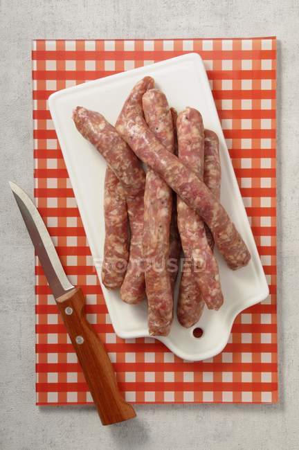 Fresh raw sausages — Stock Photo