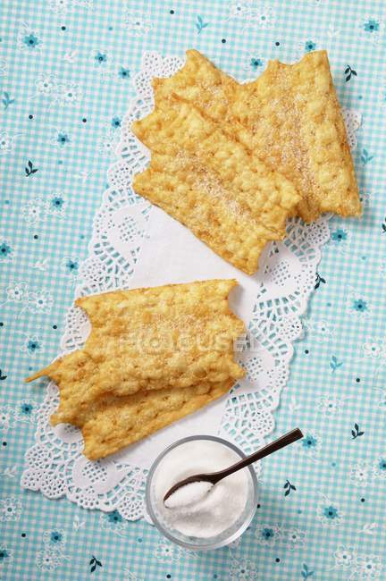 Top view of Oreillettes deep-fried pastries with sugar — Stock Photo