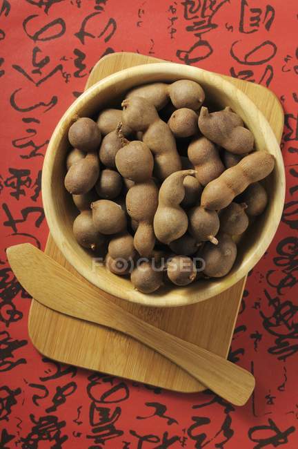 Tamarinds in wooden bowl — Stock Photo