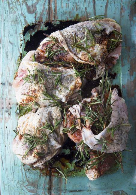 Closeup top view of marinated chicken with rosemary — Stock Photo