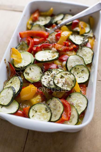Grilled vegetables with thyme in white dish with spoon — Stock Photo