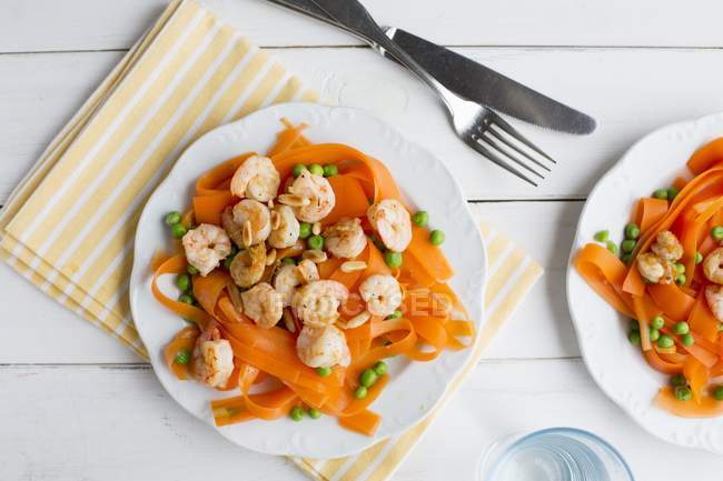 Carrot tagliatelle pasta with prawns — Stock Photo