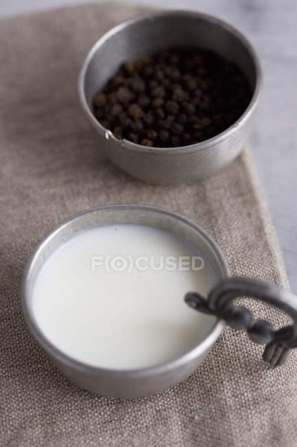 Soured milk and peppercorns — Stock Photo
