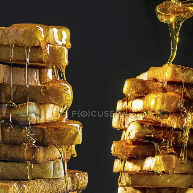 Stacks of toast with honey — Stock Photo
