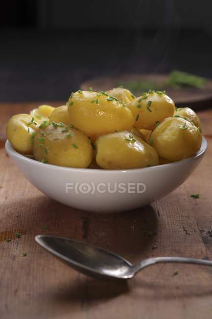Steaming new potatoes in bowl — Stock Photo
