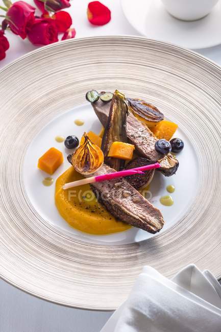 Duck breast on bed of pumpkin — Stock Photo