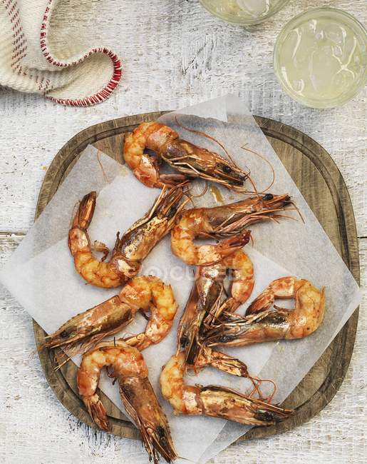 Grilled prawns on parchment paper — Stock Photo