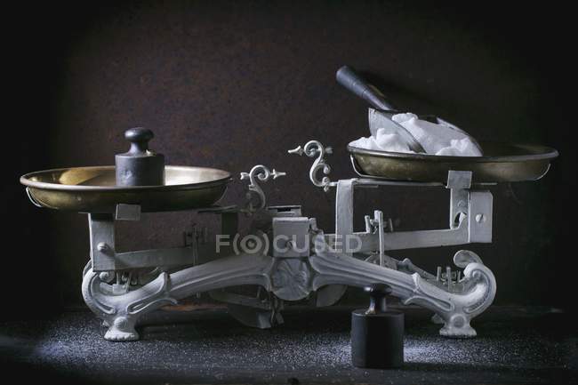 An antique pair of kitchen scales with weights — Stock Photo