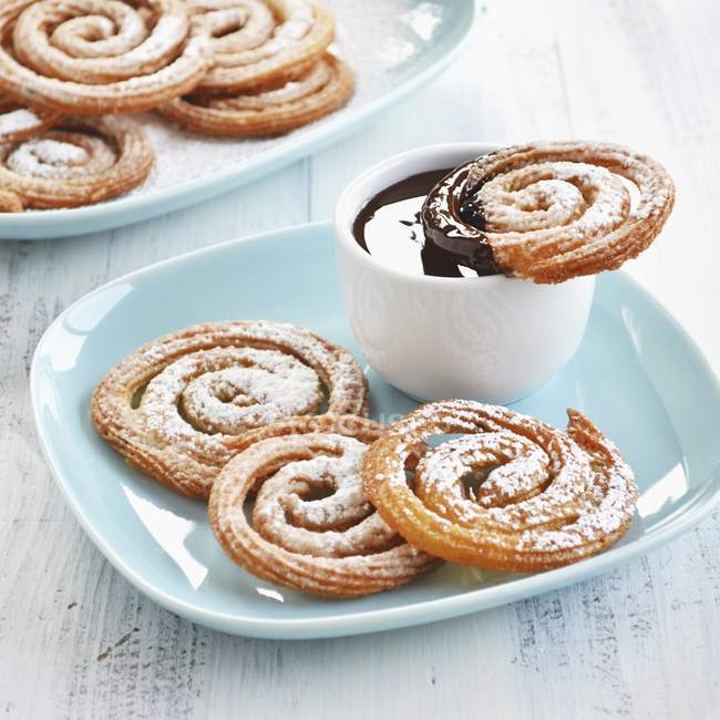 Closeup view of Churros whirls with chocolate dip — Stock Photo