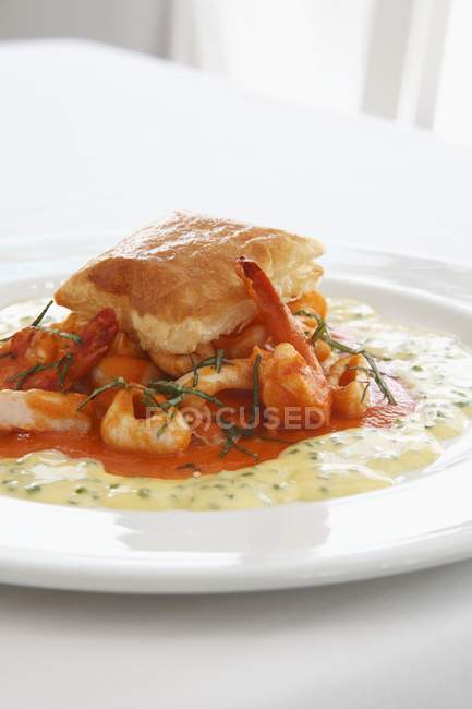 Closeup view of seafood pie with herbs and sauce — Stock Photo