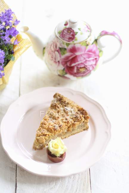 Slice of apple cake with a rose — Stock Photo