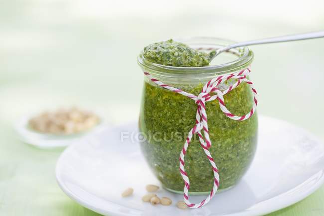 Closeup view of a tied glass jar of vegan cedar Pesto — Stock Photo