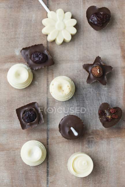 Chocolates on stick with pralines — Stock Photo