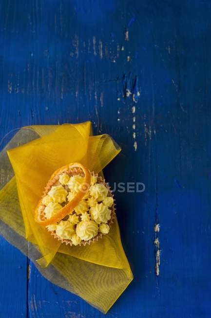 Cupcake with orange topping — Stock Photo