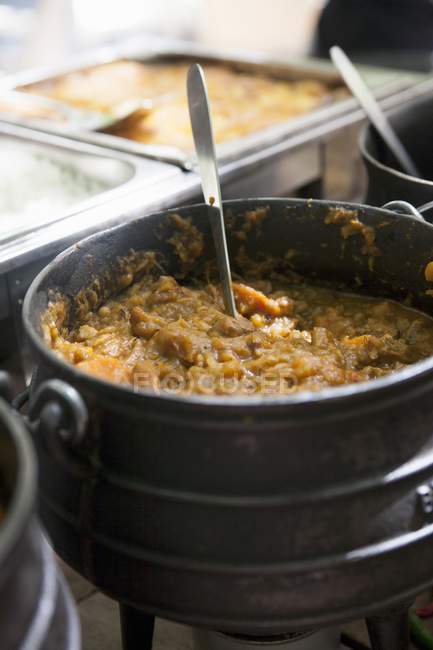 Closeup view of a curry dish in a cooking pot — Stock Photo
