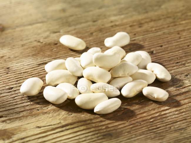 White beans on a wooden surface — Stock Photo