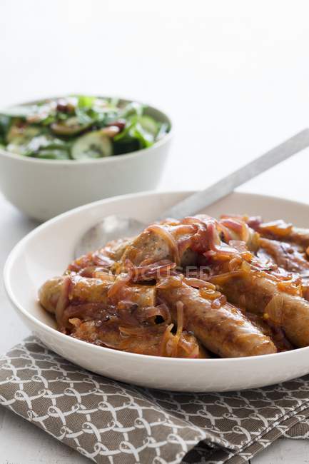 Pork sausages with onions — Stock Photo