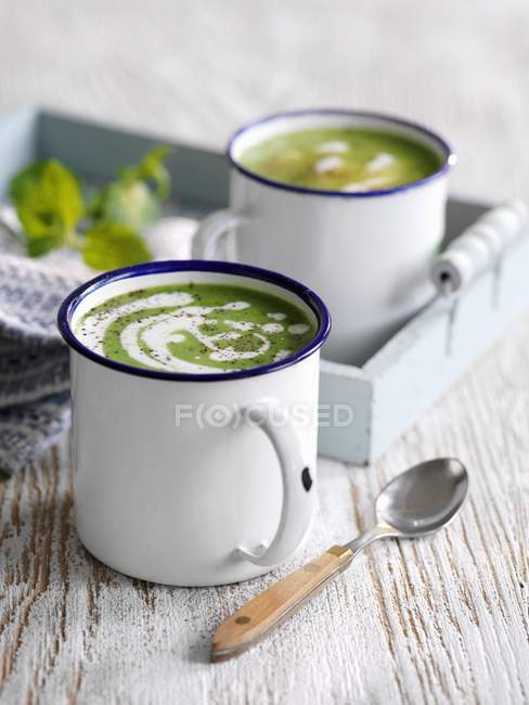Cream of pea soup with mint — Stock Photo