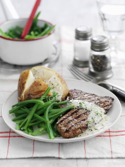 Beef steak with dill sauce — Stock Photo