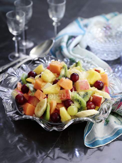 Mixed fruit salad in crystal bowl — Stock Photo