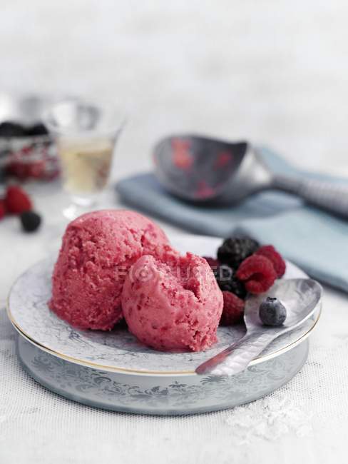 Raspberry ice cream on decorated plate — Stock Photo