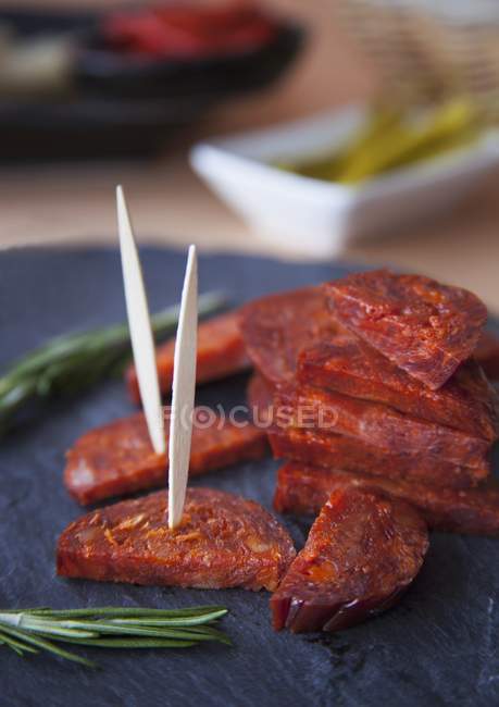 Salami slices with wooden sticks — Stock Photo
