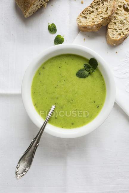 Pea soup in bowl with bread — Stock Photo