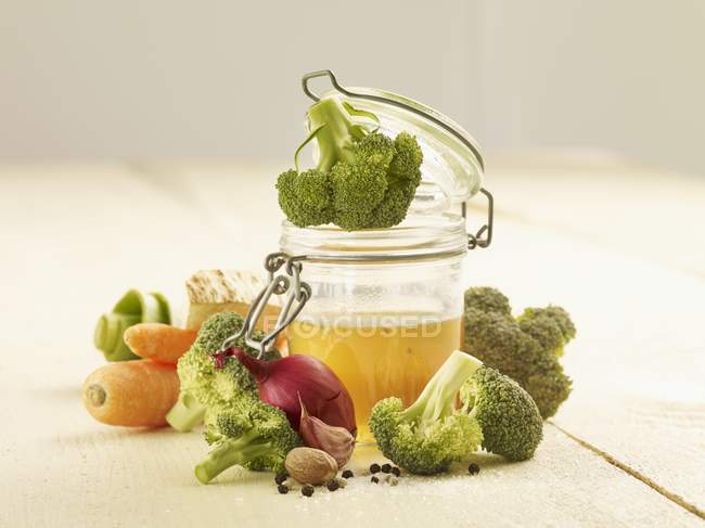 Ingredients for broccoli soup in jar and over wooden surface — Stock Photo