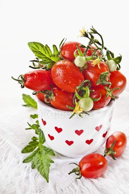 Cherry tomatoes in vase — Stock Photo