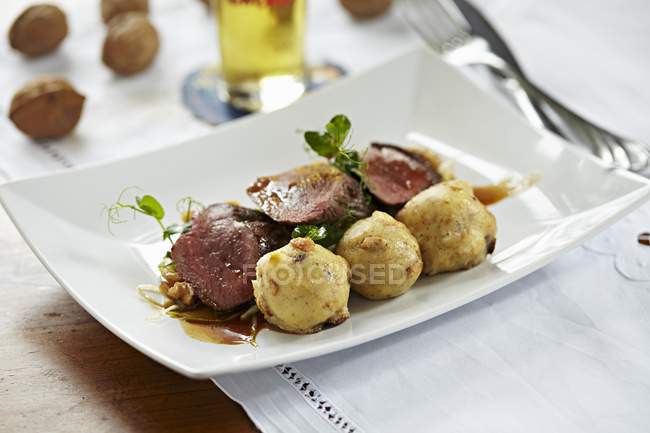 Saddle of venison with sauce — Stock Photo