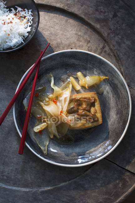 Onions on tofu with side of rice — Stock Photo