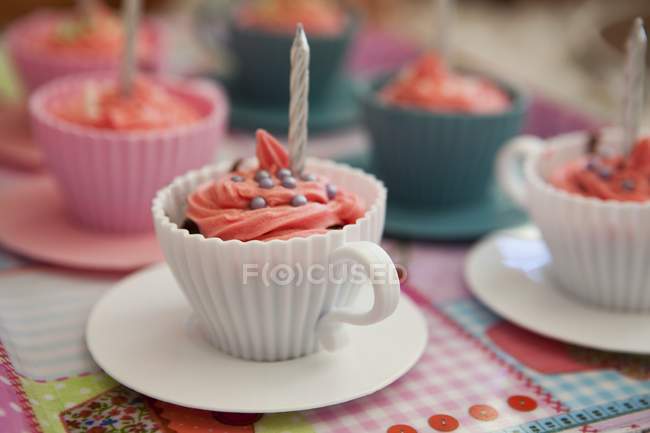 Pink cupcakes with birthday candles — Stock Photo